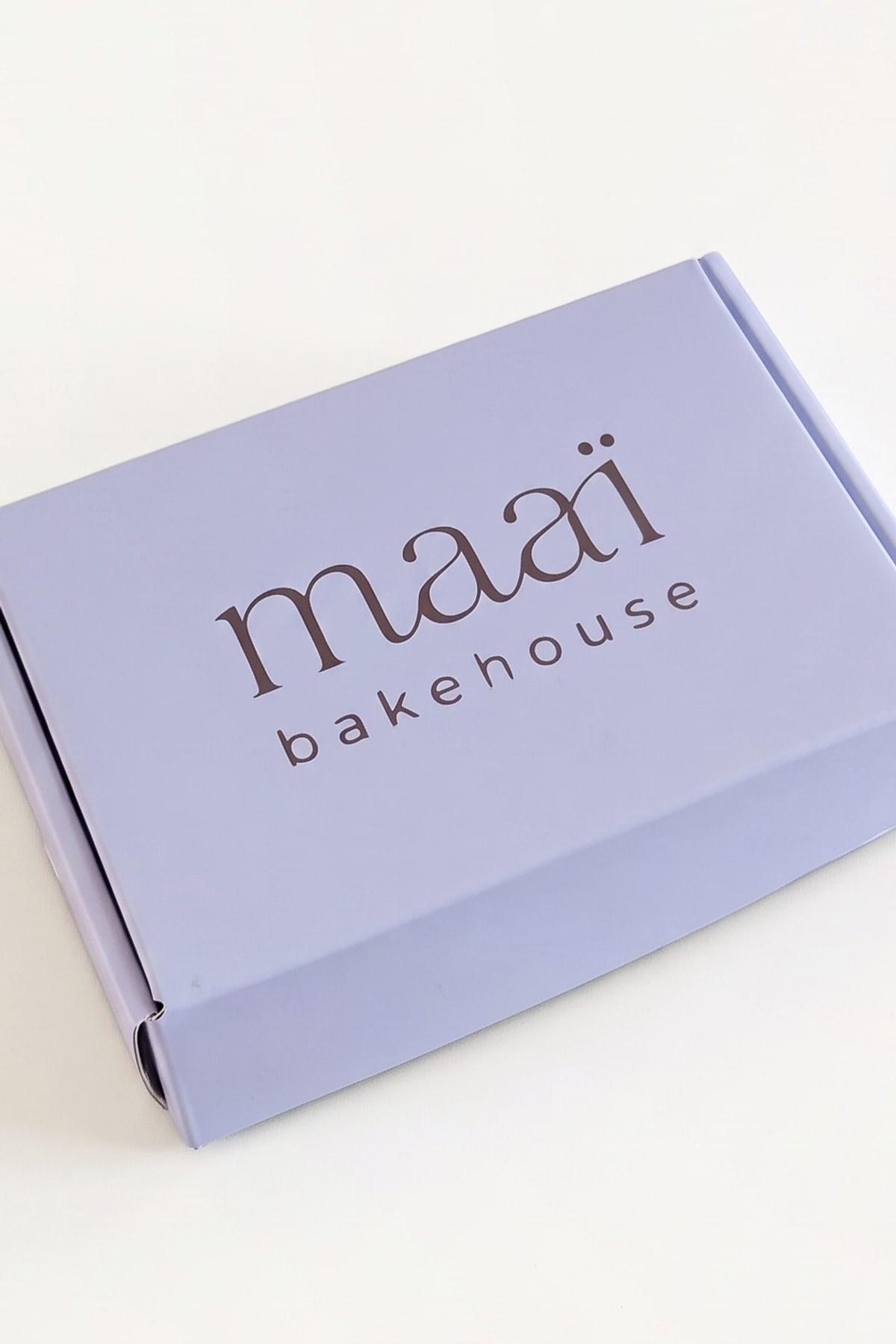 The closed lilac box of six with maaï bakehouse on the lid